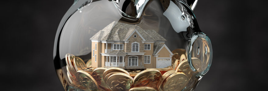 Glass Piggy Bank With Coins And House. Mortgage, Savings For Rea