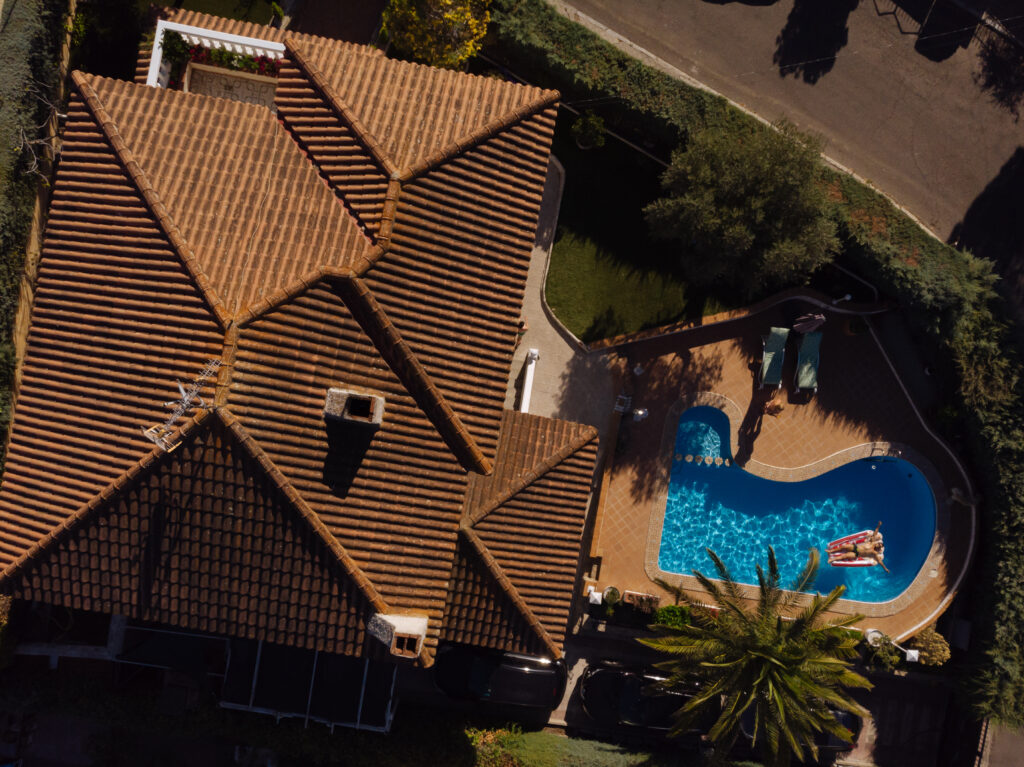 Man On Beach Mat In Swimming Pool Of A Villa House